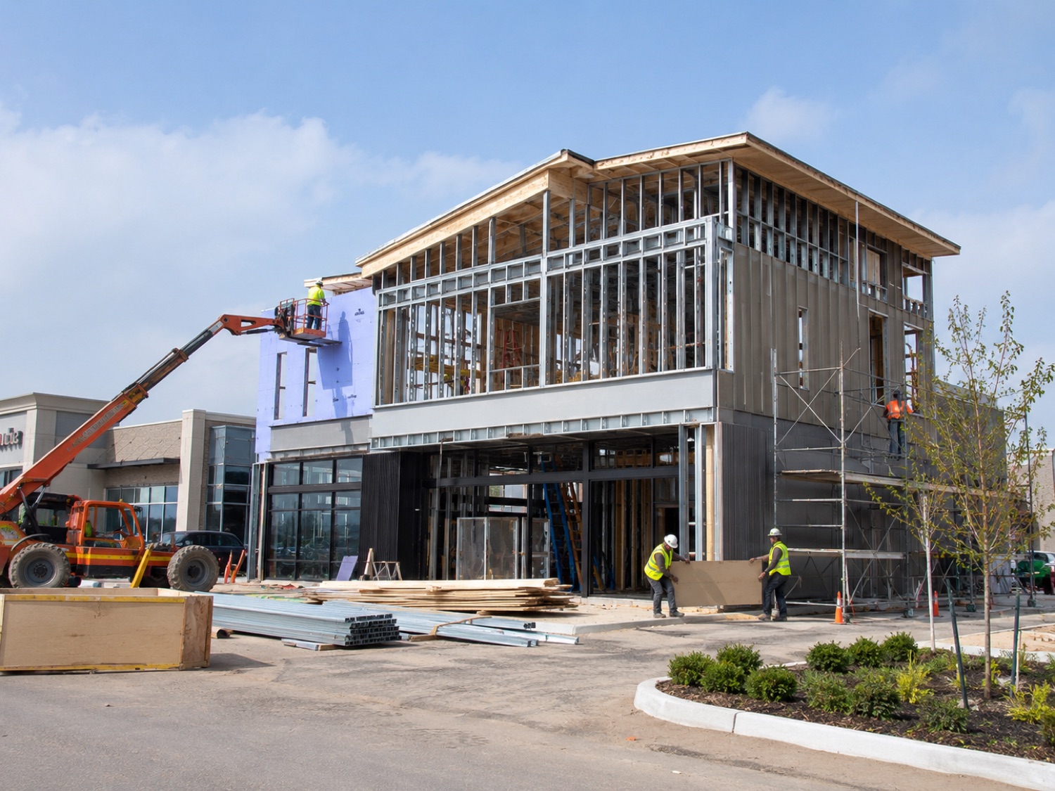 Steel-frame commercial building under Construction with crew on site